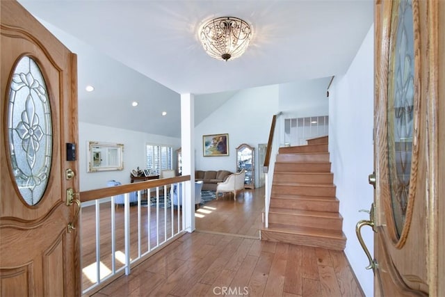 17000 Addison St, Encino, CA 91316 - entrance foyer with a chandelier, hardwood / wood-style flooring, stairs, vaulted ceiling, and recessed lighting