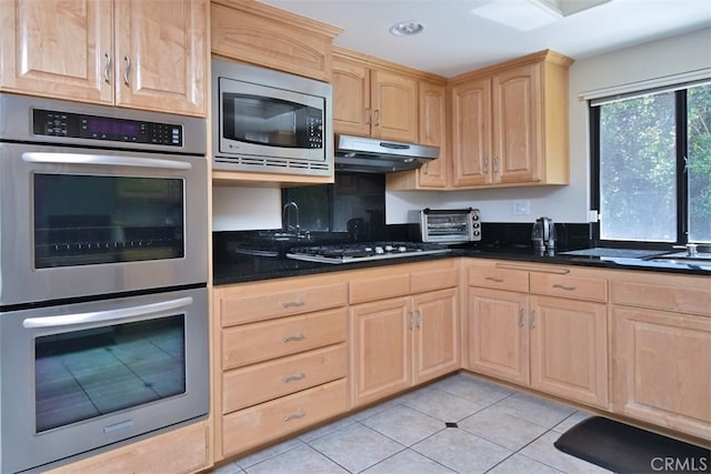 17000 Addison St, Encino, CA 91316 - kitchen with light brown cabinetry, appliances with stainless steel finishes, light tile patterned flooring, recessed lighting, and under cabinet range hood