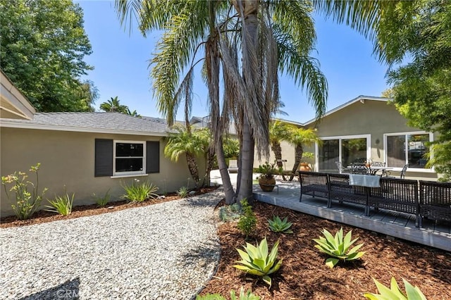 1544 3rd St, Manhattan Beach, CA 90266 - view of side of property with stucco siding and a wooden deck