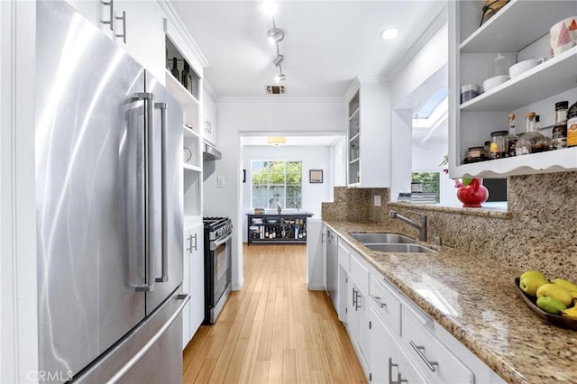 1544 3rd St, Manhattan Beach, CA 90266 - kitchen featuring stainless steel appliances, open shelves, tasteful backsplash, white cabinetry, and light stone countertops