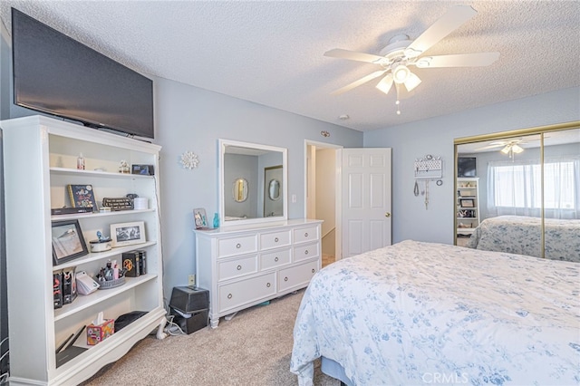 43840 Bobby Jones Dr Unit 22, Lancaster, CA 93536 - carpeted bedroom featuring a textured ceiling, a closet, and a ceiling fan