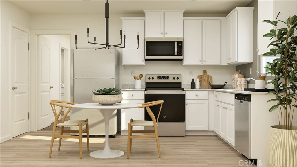 14811 Indigo Rd, Apple Valley, CA 92307 - kitchen featuring appliances with stainless steel finishes, a chandelier, light wood finished floors, white cabinetry, and light countertops