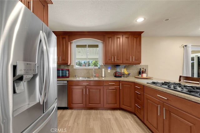 1219 N Van Buren St, Placentia, CA 92870 - kitchen featuring stainless steel appliances, light wood-style floors, decorative backsplash, brown cabinets, and recessed lighting