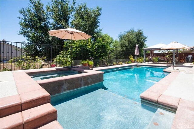 8718 Snowmass Peak Way, Riverside, CA 92508 - view of pool with an in-ground hot tub, a fenced backyard, a patio area, and a gazebo