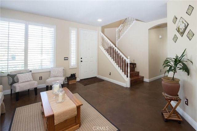 8718 Snowmass Peak Way, Riverside, CA 92508 - living area featuring stairway, arched walkways, concrete floors, and recessed lighting