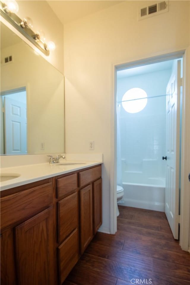 8718 Snowmass Peak Way, Riverside, CA 92508 - bathroom with double vanity, wood finished floors, and shower / bathtub combination