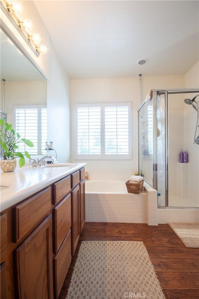 8718 Snowmass Peak Way, Riverside, CA 92508 - full bath featuring a garden tub, wood finished floors, a stall shower, and double vanity