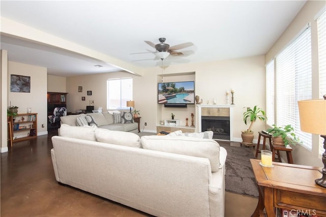8718 Snowmass Peak Way, Riverside, CA 92508 - living room featuring ceiling fan, a fireplace, and concrete flooring