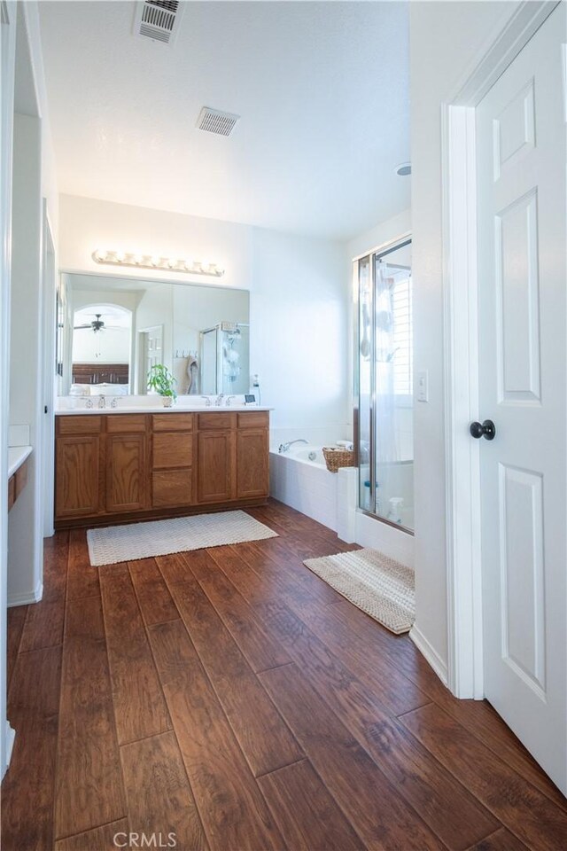 8718 Snowmass Peak Way, Riverside, CA 92508 - bathroom with wood-type flooring, a shower stall, double vanity, and a bath
