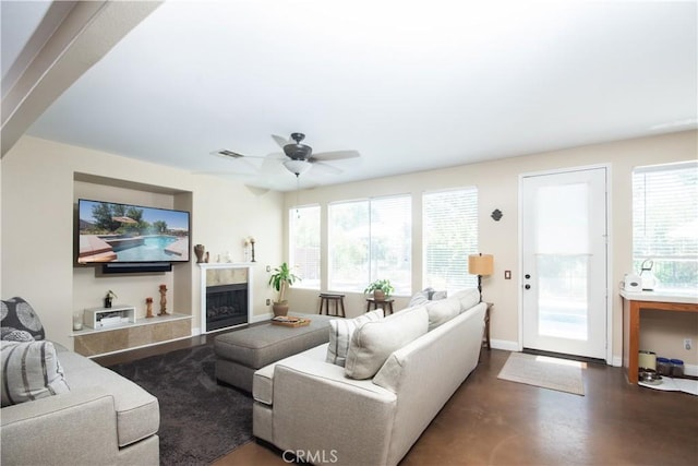 8718 Snowmass Peak Way, Riverside, CA 92508 - living room with finished concrete flooring, a ceiling fan, and a fireplace