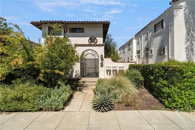 1128 Huntington Dr Unit C, South Pasadena, CA 91030 - mediterranean / spanish-style house with stucco siding, a tile roof, and a gate