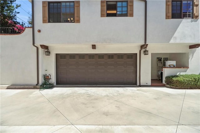 1128 Huntington Dr Unit C, South Pasadena, CA 91030 - view of front facade with stucco siding, an attached garage, and driveway
