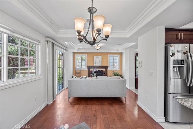 1128 Huntington Dr Unit C, South Pasadena, CA 91030 - living room featuring a chandelier, hardwood / wood-style floors, a fireplace, a raised ceiling, and crown molding