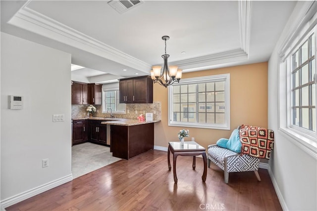 1128 Huntington Dr Unit C, South Pasadena, CA 91030 - kitchen featuring a tray ceiling, dark brown cabinetry, a chandelier, light wood-style flooring, and ornamental molding