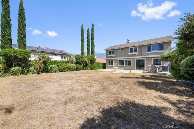 15353 Isabel Ln, Fontana, CA 92336 - rear view of property with stucco siding and a patio area