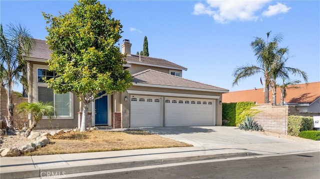 15353 Isabel Ln, Fontana, CA 92336 - view of property hidden behind natural elements with an attached garage, stucco siding, driveway, and a tiled roof