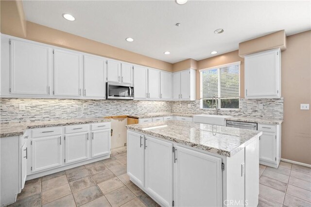 15353 Isabel Ln, Fontana, CA 92336 - kitchen featuring appliances with stainless steel finishes, white cabinets, backsplash, light stone countertops, and recessed lighting