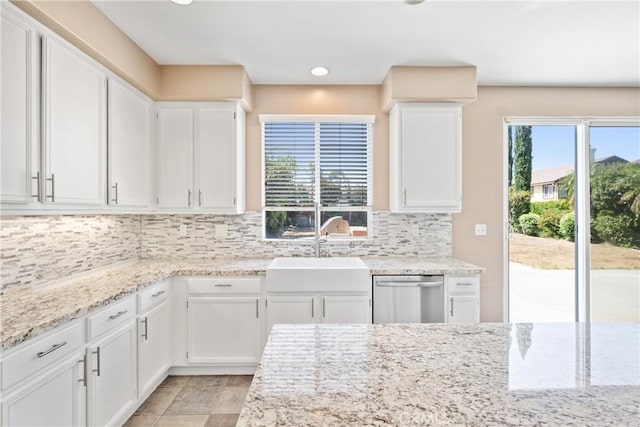 15353 Isabel Ln, Fontana, CA 92336 - kitchen with stainless steel dishwasher, white cabinetry, decorative backsplash, light stone counters, and recessed lighting