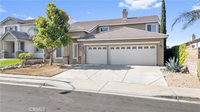 15353 Isabel Ln, Fontana, CA 92336 - view of front of home with a garage, concrete driveway, and stucco siding