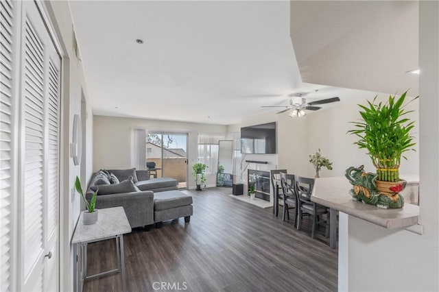 3623 Legato Ct, Pomona, CA 91766 - living area featuring dark wood-style floors, a ceiling fan, and a fireplace with flush hearth