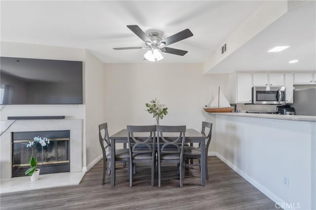 3623 Legato Ct, Pomona, CA 91766 - dining room with wood finished floors, a ceiling fan, and a glass covered fireplace