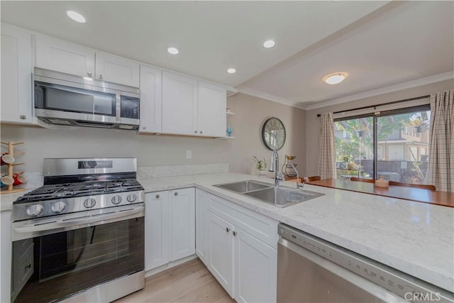 2323 S Cutty Way Unit 58, Anaheim, CA 92802 - kitchen featuring appliances with stainless steel finishes, white cabinetry, open shelves, crown molding, and light stone counters