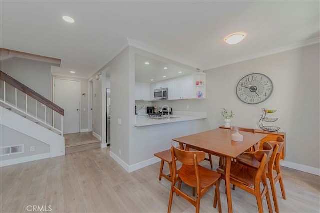2323 S Cutty Way Unit 58, Anaheim, CA 92802 - dining space with ornamental molding, stairs, light wood-type flooring, and recessed lighting