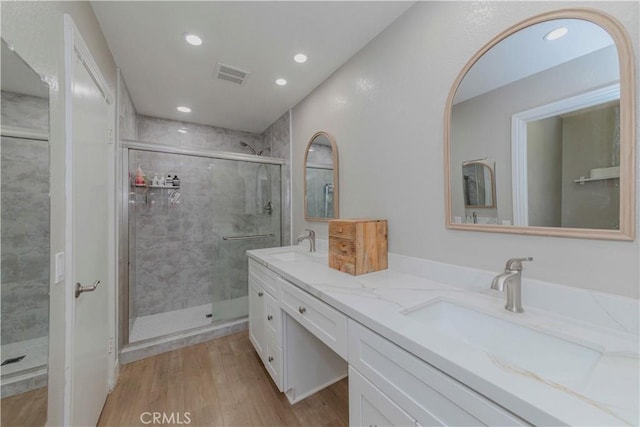 2323 S Cutty Way Unit 58, Anaheim, CA 92802 - full bath featuring double vanity, a shower stall, wood finished floors, and recessed lighting