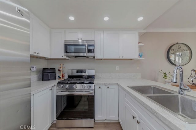 2323 S Cutty Way Unit 58, Anaheim, CA 92802 - kitchen featuring appliances with stainless steel finishes, white cabinetry, open shelves, ornamental molding, and recessed lighting