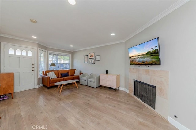 2323 S Cutty Way Unit 58, Anaheim, CA 92802 - living room featuring a fireplace, crown molding, recessed lighting, and light wood-style floors