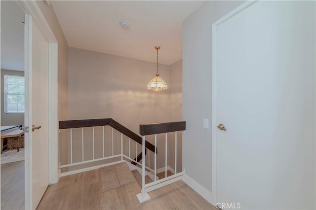2323 S Cutty Way Unit 58, Anaheim, CA 92802 - staircase featuring wood finished floors and a chandelier