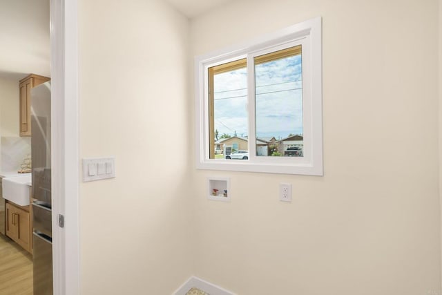 4936 Mount Elbrus Dr, San Diego, CA 92117 - washroom featuring washer hookup and light wood-style flooring