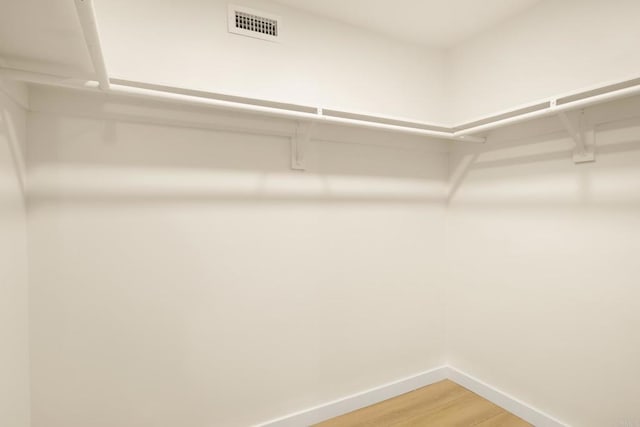 4936 Mount Elbrus Dr, San Diego, CA 92117 - walk in closet with light wood-type flooring
