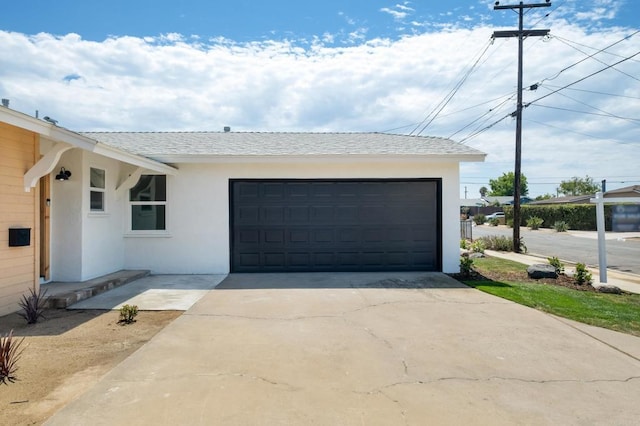 4936 Mount Elbrus Dr, San Diego, CA 92117 - view of front of home with stucco siding, an attached garage, driveway, and a shingled roof