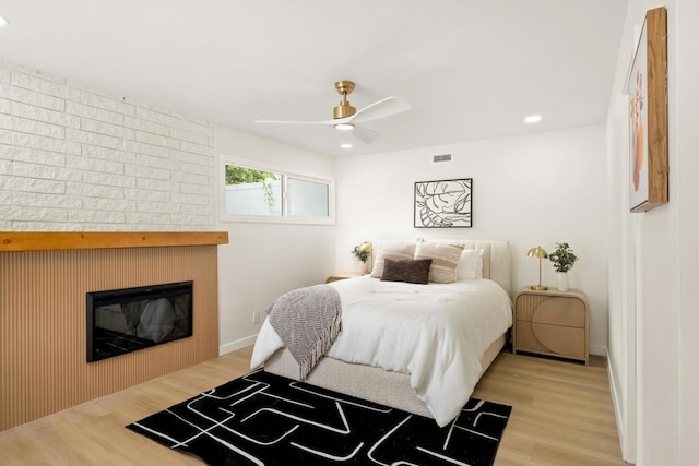 4936 Mount Elbrus Dr, San Diego, CA 92117 - bedroom featuring light wood-style floors, a glass covered fireplace, recessed lighting, and a ceiling fan
