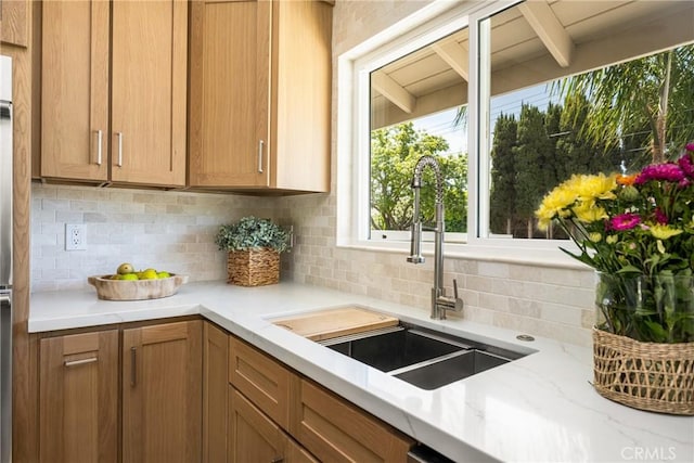 17542 Rainier Dr, North Tustin, CA 92705 - kitchen featuring decorative backsplash, light stone countertops, and brown cabinetry