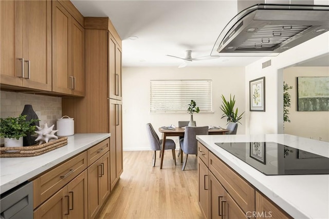 17542 Rainier Dr, North Tustin, CA 92705 - kitchen with black electric cooktop, ventilation hood, tasteful backsplash, ceiling fan, and light wood-style flooring