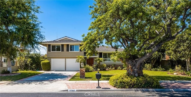 17542 Rainier Dr, North Tustin, CA 92705 - split level home featuring driveway, a front lawn, and a garage