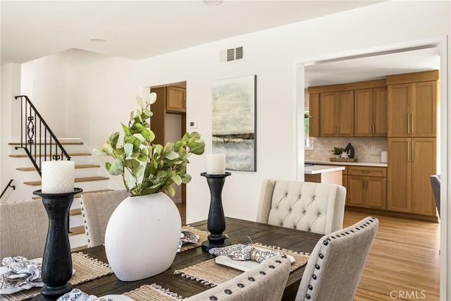17542 Rainier Dr, North Tustin, CA 92705 - dining area with stairway and light wood finished floors