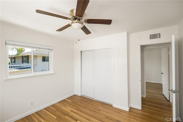 17542 Rainier Dr, North Tustin, CA 92705 - unfurnished bedroom with wood finished floors, a closet, and a ceiling fan