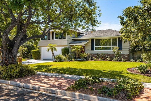 17542 Rainier Dr, North Tustin, CA 92705 - tri-level home with concrete driveway, a front yard, a garage, and brick siding