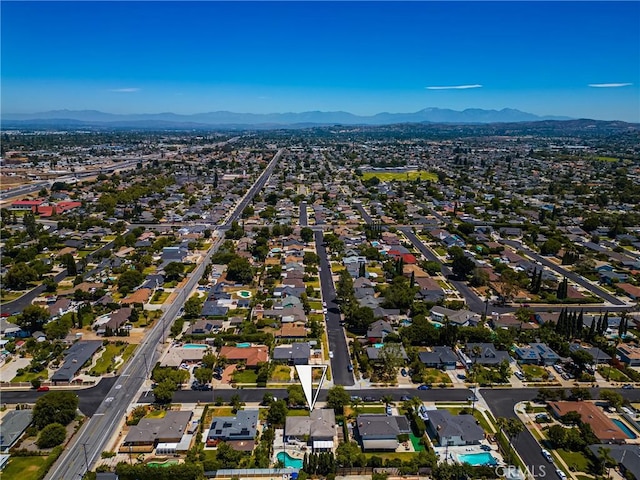 17542 Rainier Dr, North Tustin, CA 92705 - aerial overview of property's location featuring a mountainous background and nearby suburban area