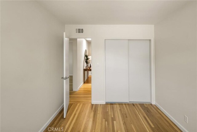 17542 Rainier Dr, North Tustin, CA 92705 - unfurnished bedroom featuring light wood-type flooring and a closet