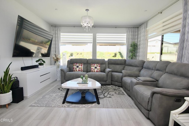 1622 Trailview Dr, Beaumont, CA 92223 - living room with healthy amount of natural light, a chandelier, and light wood-style floors
