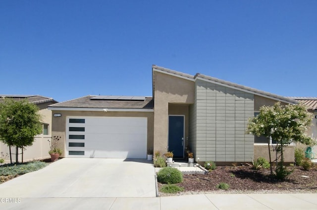 1622 Trailview Dr, Beaumont, CA 92223 - mid-century home with a garage, concrete driveway, solar panels, and stucco siding