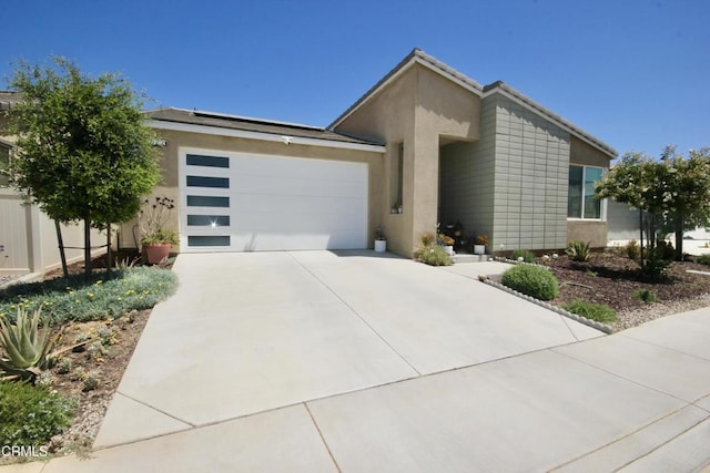 1622 Trailview Dr, Beaumont, CA 92223 - mid-century modern home with a garage, concrete driveway, stucco siding, and solar panels