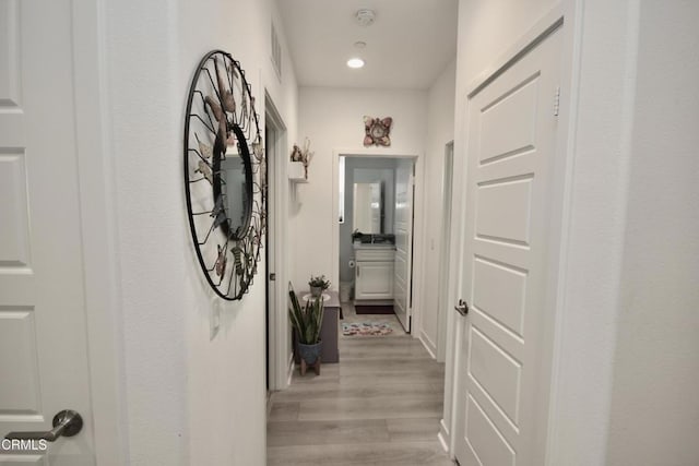1622 Trailview Dr, Beaumont, CA 92223 - hallway with light wood finished floors and recessed lighting