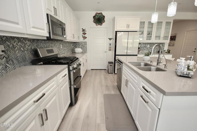 1622 Trailview Dr, Beaumont, CA 92223 - kitchen featuring stainless steel appliances, white cabinetry, backsplash, and light wood-style flooring