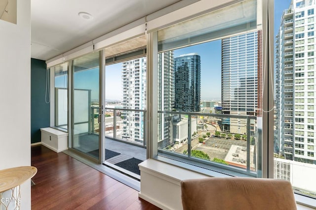 1155 S Grand Ave Unit 1510, Los Angeles, CA 90015 - spare room with a view of city, expansive windows, healthy amount of natural light, and wood finished floors