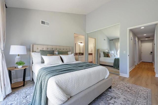 5452 Gooseberry Way, Oceanside, CA 92057 - bedroom with light wood-style floors, lofted ceiling, and connected bathroom